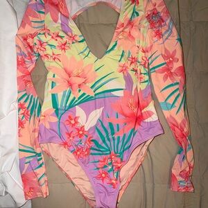 Billabong women’s Long Sleeve Floral One-Piece Swimsuit in Peach & Lavender.